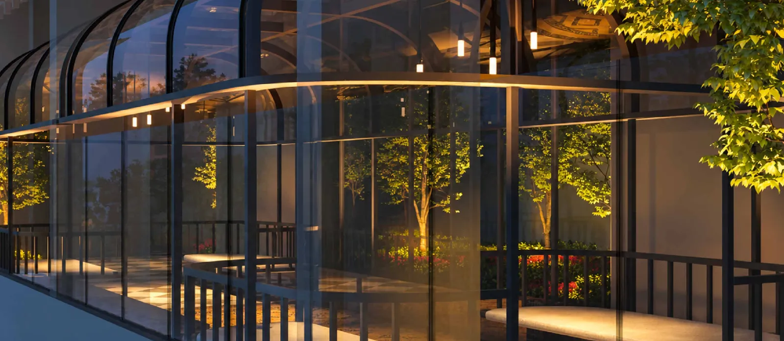 MABA Suitez loft lounge in a glass conservatory with trees and warm lighting at night, artist's impression